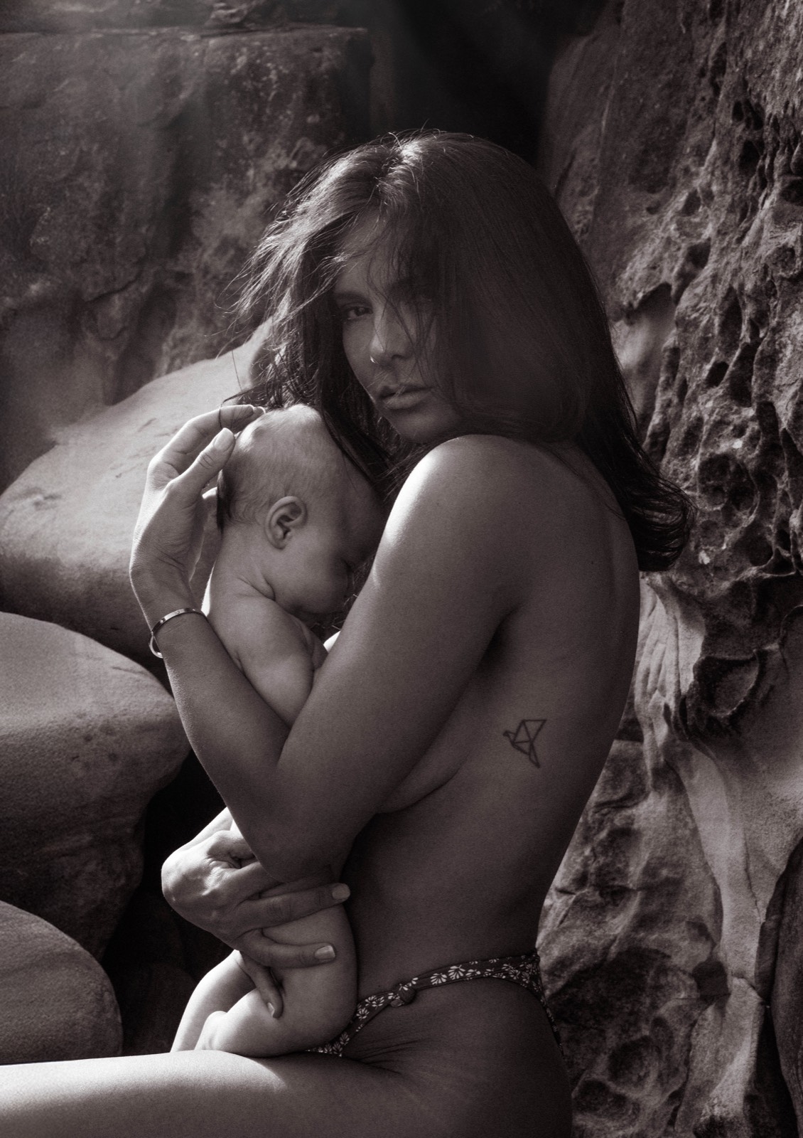 Intimate portrait of a mother holding her sleeping baby